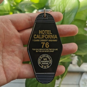 Detail of black Hotel California motel keychain with gold UV printed graphics