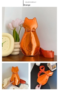 Detailed views of orange patent leather cat-shaped crossbody bag with gold buckle strap