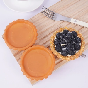 Realistic artificial blueberry tart model with crust shells on a wooden tray for DIY crafts