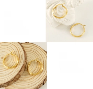 Detailed close-up of 18K gold plated hoop earrings showing Greek key pattern and polishing