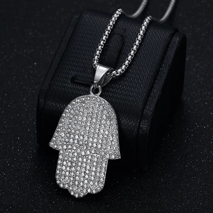 Hiphop silver Hamsa hand pendant necklace with iced out crystals on jewelry display