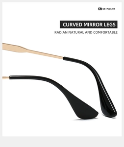 Detalle de las patillas curvas de gafas en oro y negro con bisagras de metal