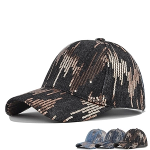 Detail of sequin wave pattern on denim baseball cap showing multiple color options