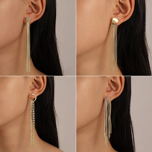 Detailed view of four elegant long tassel earrings with sparkling zircon and gold finish