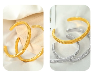 Detailed view of hammered texture on gold and silver minimalist open cuff bracelets