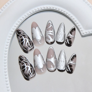 Handmade silver chrome and marble press-on nails in long almond stiletto shape