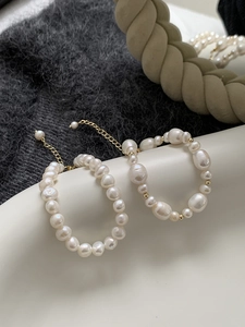 Close-up of irregular freshwater pearl bracelets with gold-plated adjustable chain links