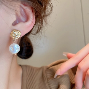 French style metallic gold pleated earrings with white baroque pearls on model