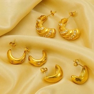 Detalle de pendientes en acero chapado en oro 18K con textura de cuerda y motivos de estrella