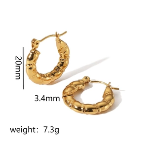 Detailed close-up of gold titanium steel earrings with woven texture and size specs