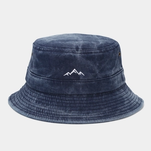 Detail of mountain embroidery on navy washed denim bucket hat with metal eyelets