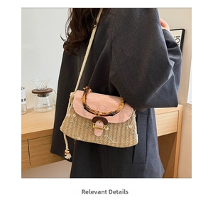 Detail of straw bag with flower embroidery, bamboo handle and cotton rope strap