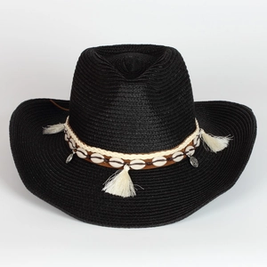 Detail of black woven cowboy straw hat with shell decorative band and metal tassels