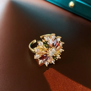 Detailed close-up of a gold-plated flower ring with vibrant multicolor zircon crystals