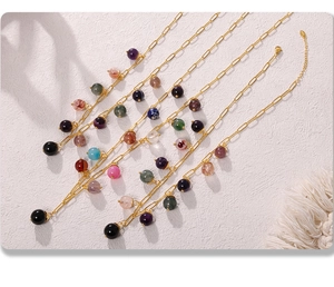 Detail of colorful natural stone beads on a gold stainless steel bohemian chain