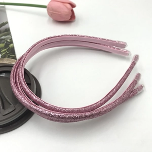 Detail view of pink sequin headbands with glitter finish and protective end caps