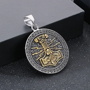 Macro shot of Viking Mjölnir pendant in silver and gold steel with Celtic knot details