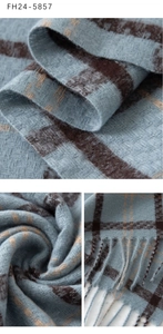Macro shot of soft plaid scarf texture with fringe detail and woven fabric pattern