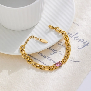 Detail of 18k gold plated Cuban chain bracelet with rectangular pink zircon stone