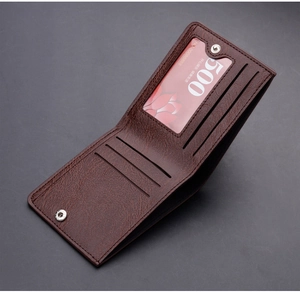 Macro view of dark brown leather wallet showing multiple card slots and secure snap pocket