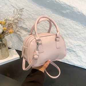 Pink PU leather bowling handbag with silver hardware and adjustable strap for women