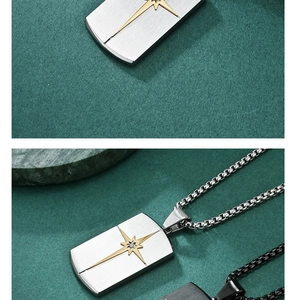 Macro detail of stainless steel necklace featuring a golden starburst pendant on green surface