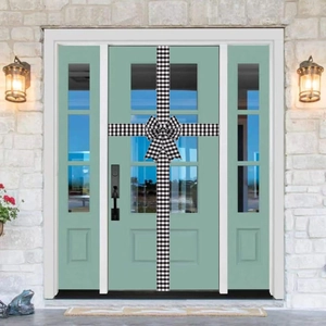 Detail of black and white buffalo plaid decorative door ribbon with a large bow