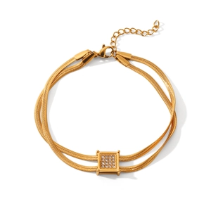 Close-up of double-layered snake chain bracelet with square zircon pendant in gold finish