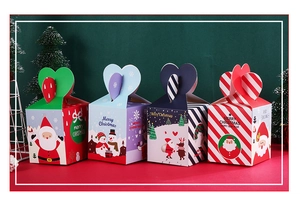 Set of four Christmas gift boxes with heart-shaped handles and festive character prints