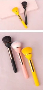 Detail of soft high-density fiber bristles and golden metal accents on makeup brushes