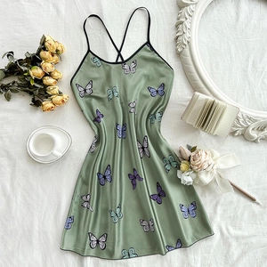 Elegant grass green satin slip dress featuring colorful butterfly prints and cross back straps
