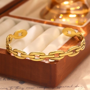 Close-up of a high-polish 18k gold plated stainless steel chain link open cuff bracelet