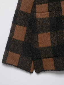 Detailed macro view of the fluffy mohair texture and vintage plaid pattern on the cuff