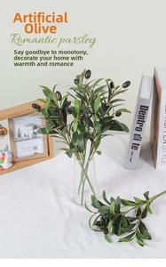 Detailed view of artificial olive branches with fruit in a vase for home decor