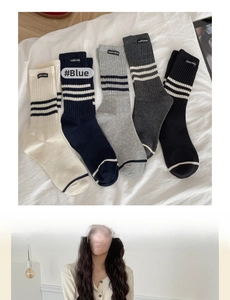 Detail of five-pack striped crew socks in beige, navy, grey and black with woven labels