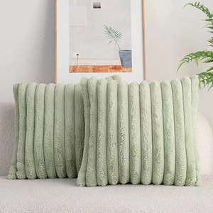 Detail of light green faux rabbit fur pillow showing soft plush striped texture