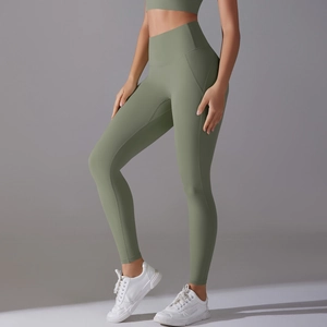 Detail view of sage green high-waisted yoga pants with ergonomic side seams and matte fabric
