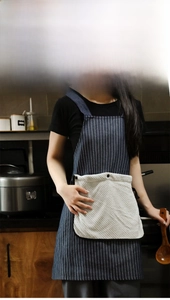 Detail of Mori style apron featuring a detachable coral fleece hand towel and blue stripes