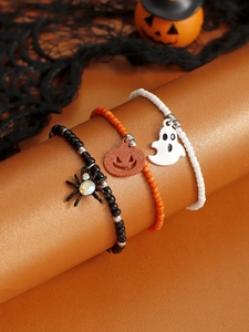 Detailed view of Halloween beaded bracelets with spider, pumpkin, and ghost charms