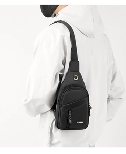 Rear view of a black water-resistant oxford fabric chest bag with adjustable straps