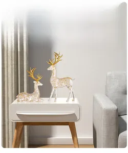 Macro detail of transparent reindeer statues with gold foil flakes and polished gold antlers