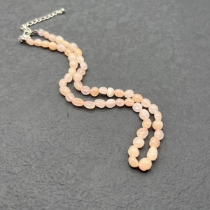 Close-up of pink quartz beads necklace with adjustable stainless steel clasp