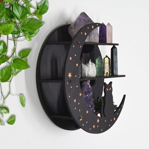 Detail of moon and cat shaped wooden shelf with gold stars and crystal display
