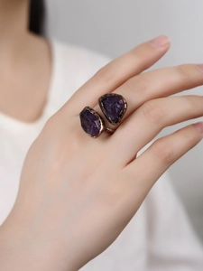 Detail of vintage bronze adjustable ring with raw purple amethyst crystal on model