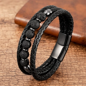 Close-up of black braided leather multi-layer bracelet with volcanic stone beads