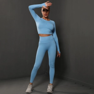 Light blue seamless yoga set with long sleeve crop top featuring thumb holes and high waist leggings