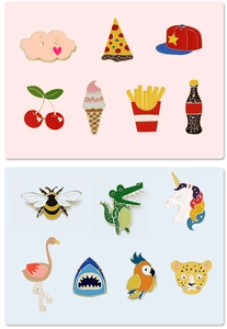 Macro view of assorted cartoon enamel pins including unicorn and food themes