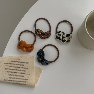 Handmade acetate hair ties with tortoiseshell and checkerboard patterns in four colors
