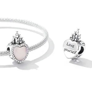 Sterling silver heart pendant with pink gemstone and castle detail on a snake chain bracelet