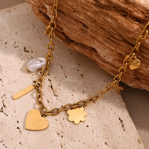 Detail of 18K gold chunky chain necklace with pink heart pendant and baroque pearl charms